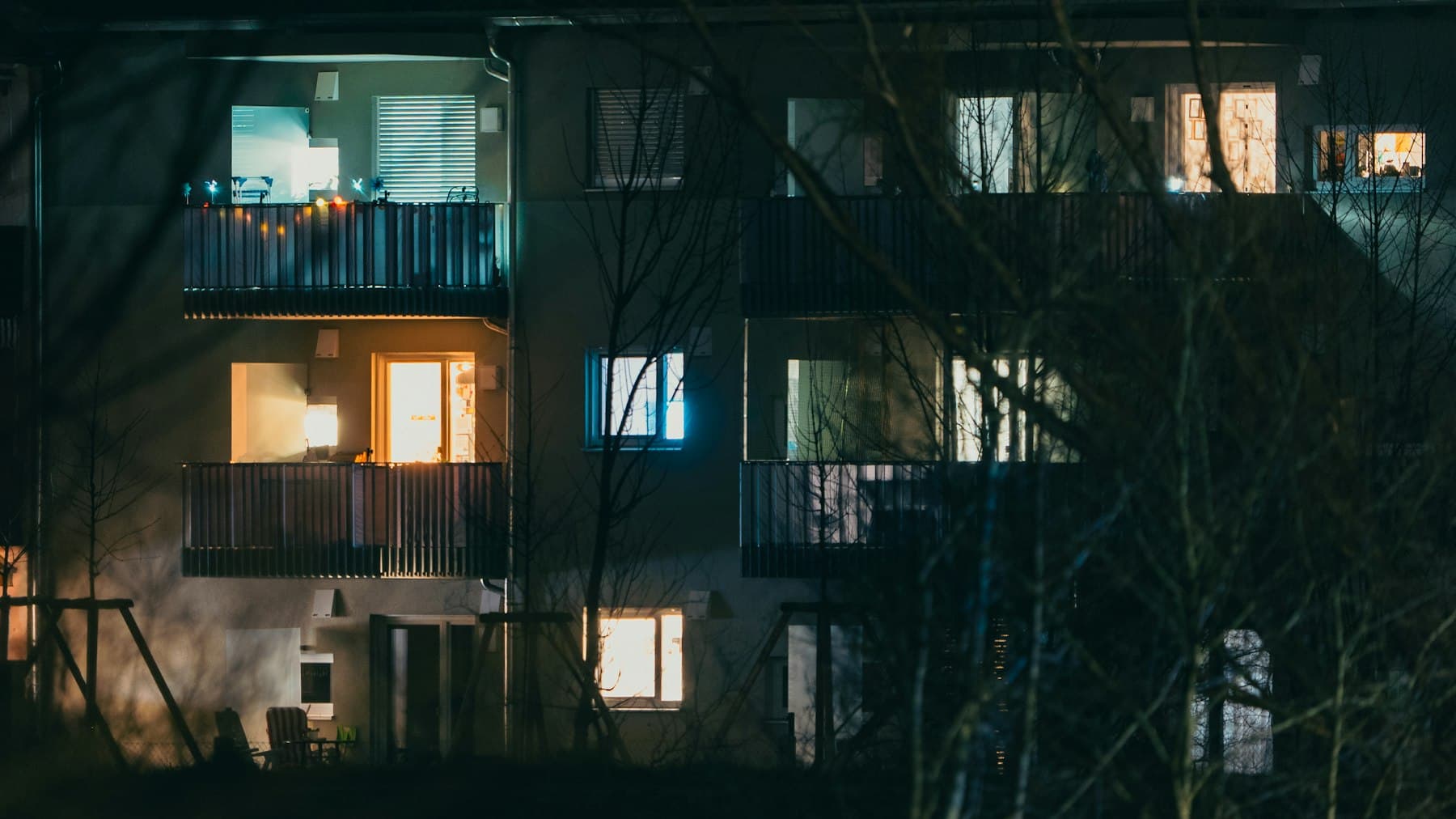 Apartment community exterior at twilight